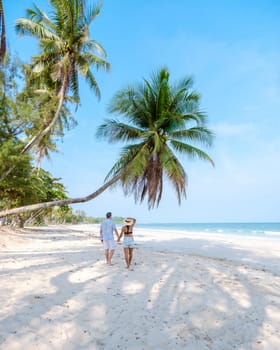 couple on vacation in Thailand Chumphon province with white tropical beach and palm trees, Wua Laen beach Chumphon area Thailand, palm tree hanging over the beach