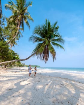 couple on vacation in Thailand Chumphon province with white tropical beach and palm trees, Wua Laen beach Chumphon area Thailand, palm tree hanging over the beach