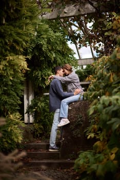 Young Cute Female Hugs Boyfriend. In Autumn Outdoor. Lovers Walking in Park. Attractive Funny Couple. Lovestory in Forest. Man and Woman. Cute Lovers in the Park. Family Concept. Happy Couple.