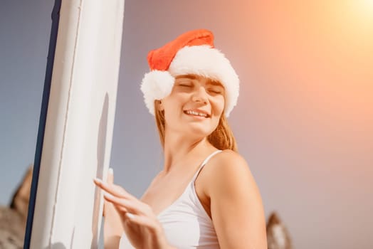 Close up shot of happy young caucasian woman looking at camera and smiling. Cute woman portrait in bikini posing on a volcanic rock high above the sea