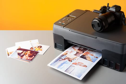 Printer printing colorful photos of people close up, yellow background, studio shot