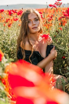 Woman poppies field. portrait of a happy woman with long hair in a poppy field and enjoying the beauty of nature in a warm summer day