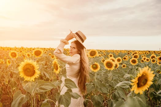 Woman in the sunflowers field. Summer time. Young beautiful woman standing in sunflower field.