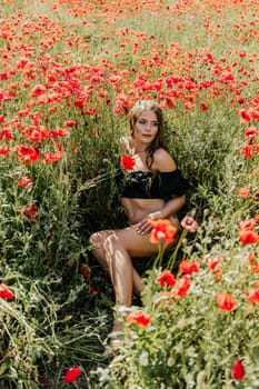 Woman poppies field. portrait of a happy woman with long hair in a poppy field and enjoying the beauty of nature in a warm summer day