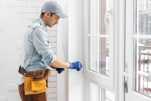 worker installing new plastic pvc window.