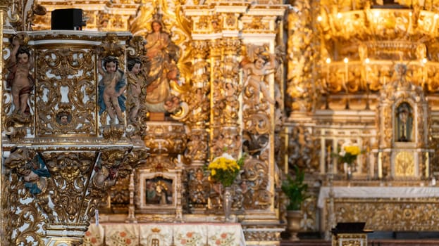 Baroque altar featuring gold leaf and religious figures.