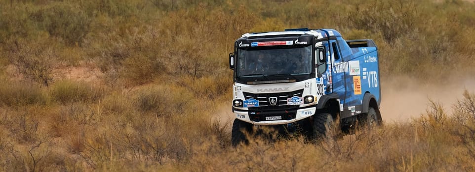 Extreme off-road racing. NEW Sports truck KAMAZ gets over the difficult part of the route during the Rally raid in sand. 14.07.2022 Kalmykia, Russia.