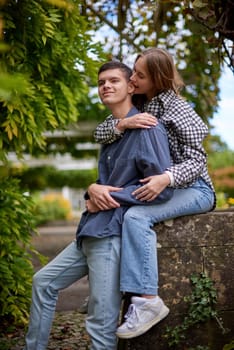 Young Cute Female Hugs Boyfriend. In Autumn Outdoor. Lovers Walking in Park. Attractive Funny Couple. Lovestory in Forest. Man and Woman. Cute Lovers in the Park. Family Concept. Happy Couple.