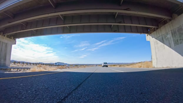 Embarking on a road trip from Nevada to California, driving on Highway 15 during the day offers scenic views and an exciting journey between states.