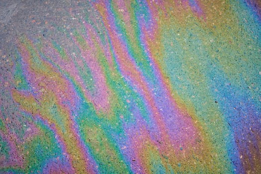 Gasoline pollution, oil, rainbow gasoline leak in the form of a glow on the sidewalk