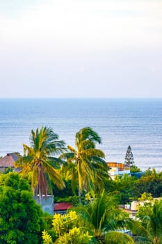 Beautiful tropical and natural city and seascape landscape panorama view with pacific ocean sea palms palm trees and beach with waves of Zicatela Puerto Escondido Oaxaca Mexico.