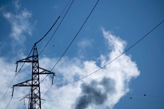 Photographic documentation of a flock of birds on an electrical pylon in blue sky 