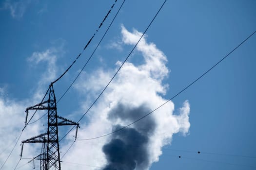 Photographic documentation of a flock of birds on an electrical pylon in blue sky 