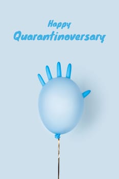 Happy anniversary concept on self-isolation and social distancing. A festive ball made of medical glove on a blue background.
