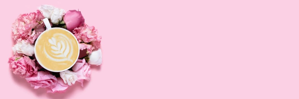 Pink background with a Cup of coffee surrounded by roses.