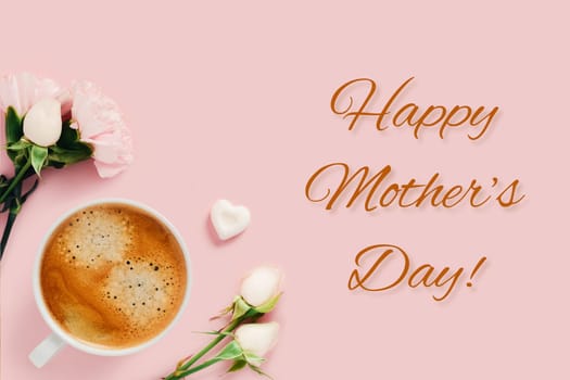 Happy Mother's Day card. Tasty coffee surranuded by white roses and one peace of sugar on pink background.