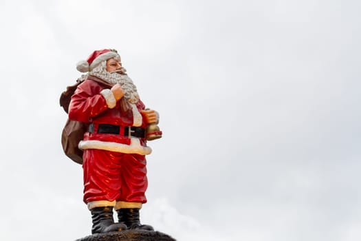 Santa Claus figurine overlooking the sky. High quality photo