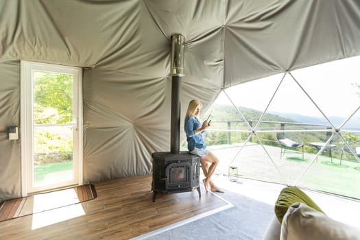 woman with tablet in dome tent.