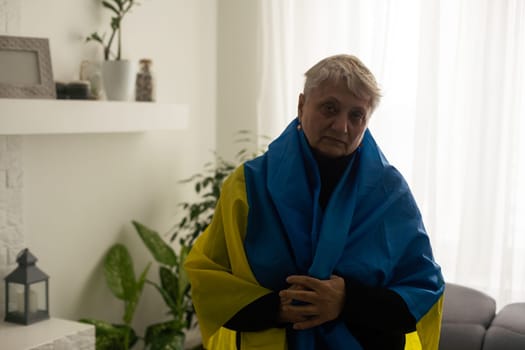 an elderly woman with a flag of Ukraine.