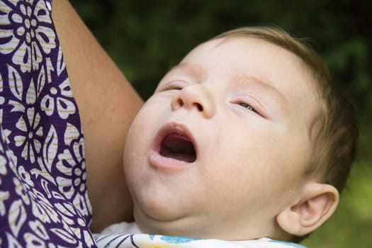 Two month old baby about to start crying. No happy expression