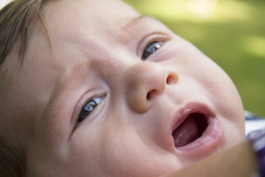 Two month old baby about to start crying. No happy expression