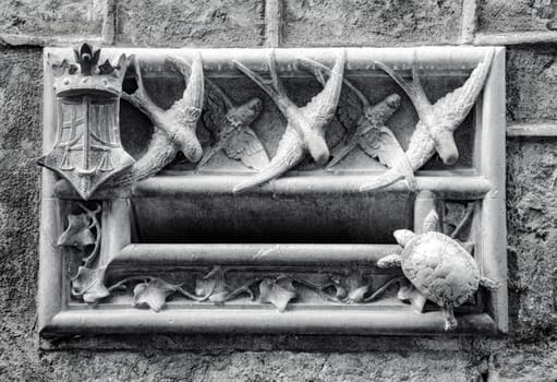 Stone mail slot in a building wall in Barcelona. Beautiful urban scenery photography with animal theme letterbox. Street scene. High quality picture for wallpaper, article