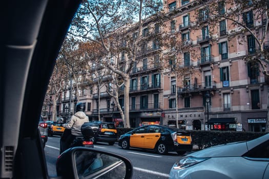 Busy street at sunset time in Beautiful Barcelona. Road in historic center with heavy traffic. Beautiful urban scenery photography with old buildings. High quality picture for wallpaper, article