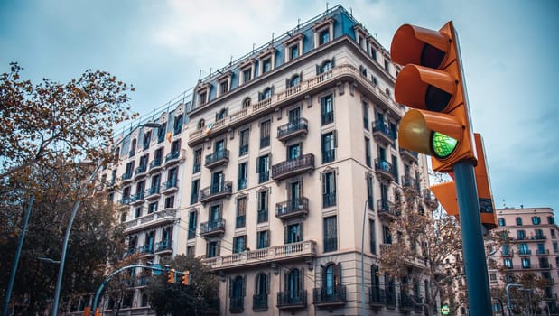Old apartment building near road. Beautiful urban scenery photography. Road traffic light. Barcelona street scene. High quality picture for wallpaper, article