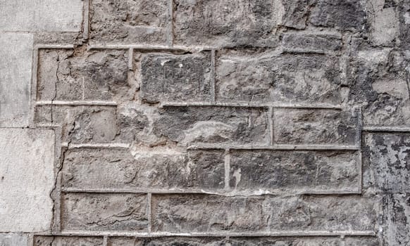 Close up old gray brick texture wall concept photo. Mediterranean architecture, urban city life. District of European town, Barcelona. High quality picture for wallpaper, travel blog.