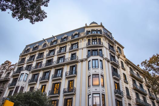 Historical building on Rambla street cityscape image. Bottom street view at sunset time in Barcelona, Spain photo. Beautiful urban scenery photography. Street scene. High quality picture for wallpaper, article