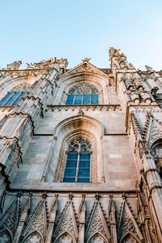 Cityscape photo of the Basilica of Saints Justus and Pastor, Barcelona. Beautiful urban scenery photography with ornamental wall. Street scene in Catalonia, Spain. High quality picture for wallpaper, article