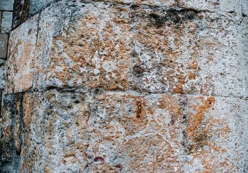 Close up old lichen brick texture wall concept photo. Medieval architecture, urban city life. District of European town, Barcelona. High quality picture for wallpaper, travel blog.