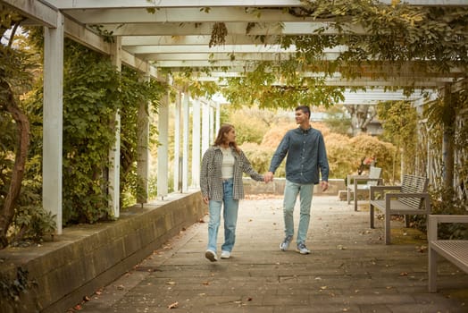 Young Cute Female Hugs Boyfriend. In Autumn Outdoor. Lovers Walking in Park. Attractive Funny Couple. Lovestory in Forest. Man and Woman. Cute Lovers in the Park. Family Concept. Happy Couple.