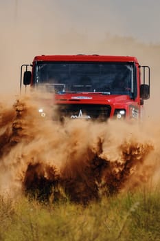 Extreme off-road racing. Sports truck MAZ Sport-auto team gets over the difficult part of the route during the Rally raid in sand. 14.07.2022 Kalmykia, Russia.