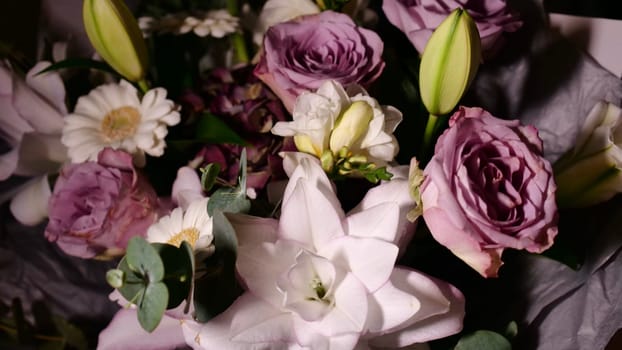 Rotating spring summer floral pastel arrangement in the background close up. Celebrating Mother's Day, International Women's Day March 8. Flowers gardenia, rose, Lilia, eucalyptus