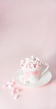 pastel peach still life with mini marshmallows in porcelain cup with pink hearts, gift for Mother's Day, Valentine's Day, trend color 2024, vertical banner,High quality photo