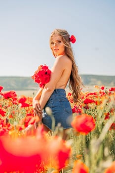 Woman poppies field. portrait of a happy woman with long hair in a poppy field and enjoying the beauty of nature in a warm summer day