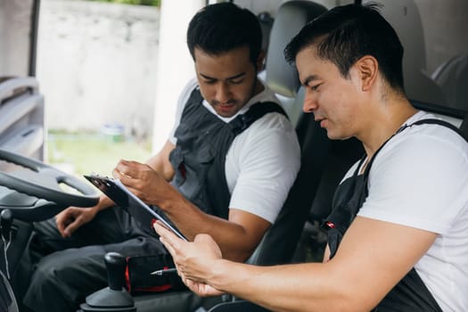 Mover workers an ethnically diverse team driving a truck for relocation service. Confidently delivering and unloading furniture. Illustrating transportation and teamwork. Moving Day Concept.