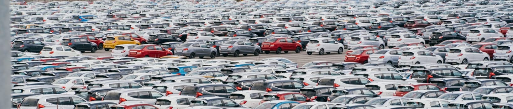 Lamchabang, Thailand - July 02, 2023 Amidst a car factory's distribution center, new sedans fill rows under the suna view from above showcases the crowded parking, a hub of global marketing.