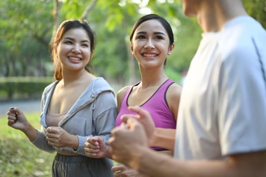 Shot of young people in sports clothing jogging in the city park. Healthy Lifestyle concept