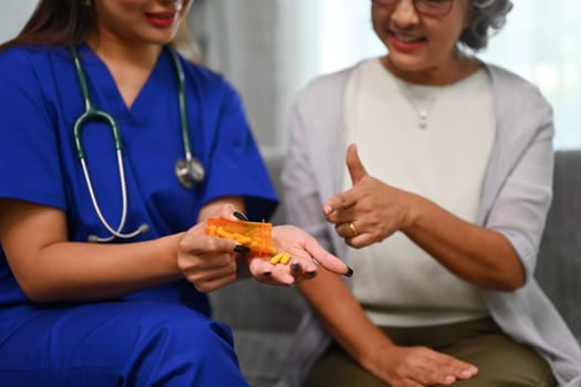 Health visitor explaining medicine dosage to senior patient. Elderly healthcare concept