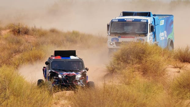 Extreme off-road racing. Sports car gets over the difficult part of the route during the Rally raid in sand. 14.07.2022 Kalmykia, Russia.