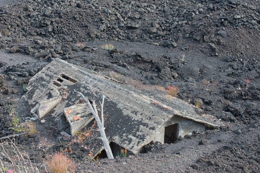 House destroyed by eruption and covered by lava on etna volcano after eruption