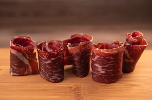 Dry-cured Spanish ham, Serrano ham, Bellota ham, Italian prosciutto crudo or Parma ham, wagyu slice. High quality photo