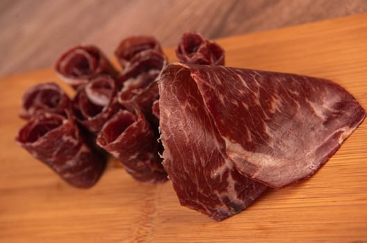 Dry-cured Spanish ham, Serrano ham, Bellota ham, Italian prosciutto crudo or Parma ham, wagyu slice. High quality photo