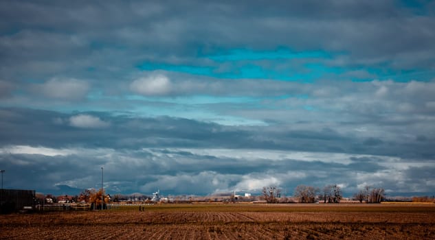 Autumn view of the countryside in Poland concept photo. Beautiful views in Polish farmland. High quality wallpaper. Ambient cloudy sky. Photo concept for travel blog, magazine, article