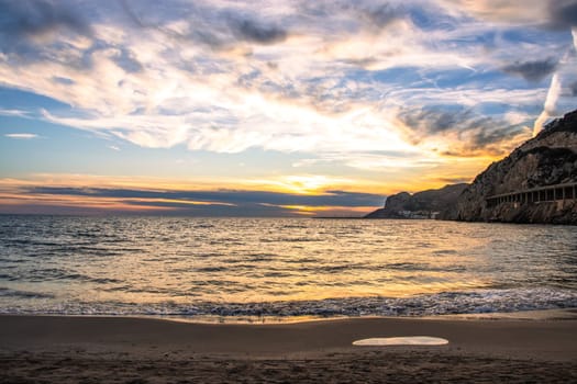 Amazing panoramic landscape of rocky shore photo. Sunrise sundown sky background with colorful clouds. Mediterranean sea. Beach concept photo. Bright seaside dusk. High quality picture for wallpaper