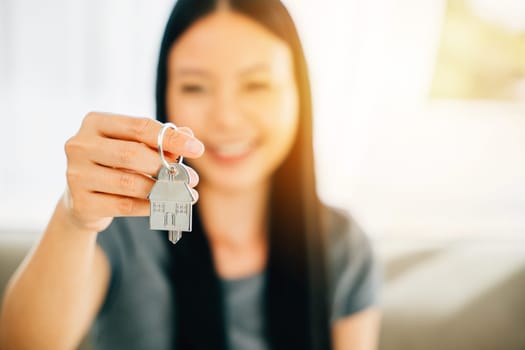A woman's hand with a house key symbolizing homeownership and achievement. Reflecting confidence happiness and the excitement of a new investment.