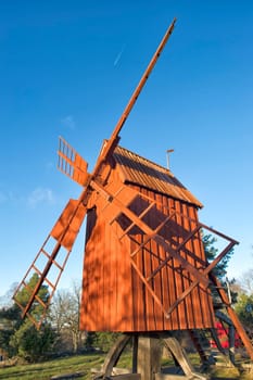 wooden windmill on the blue sky background