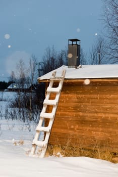 ladder on wooden hut in lapland frozen lake in winter 